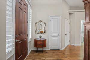 Foyer entrance featuring hardwood / wood-style floors and baseboards