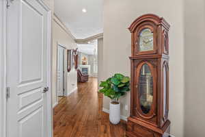 Corridor featuring hardwood / wood-style floors and recessed lighting