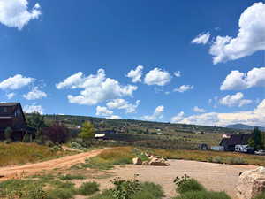 View of mountain backdrop with rural landscape