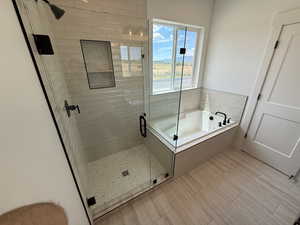 Bathroom featuring a bath and a stall shower