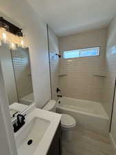 Full bath featuring vanity and shower / tub combination