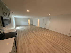 Unfurnished living room with light wood-type flooring and recessed lighting