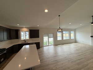 Kitchen with stainless steel electric range, plenty of natural light, open floor plan, light countertops, and recessed lighting