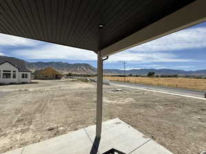 View of yard featuring a mountain view and a patio area