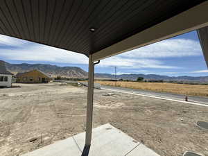 View of yard with a mountain view and a patio