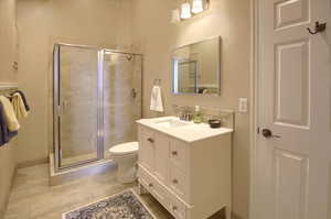 Full bath featuring vanity and a shower stall