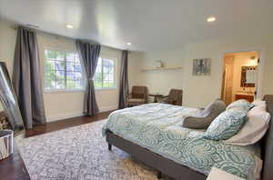 Bedroom with wood finished floors and recessed lighting