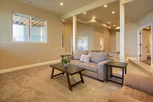 Living room with recessed lighting and light carpet