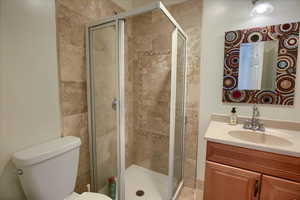 Bathroom featuring vanity and a shower stall
