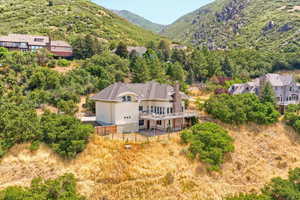 Aerial view of property and surrounding area featuring mountains