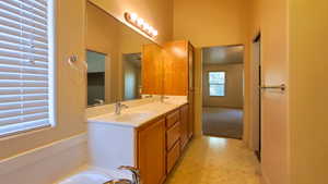 Bathroom with double vanity and a tub