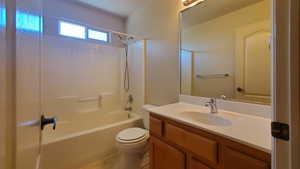 Bathroom with vanity and shower / washtub combination