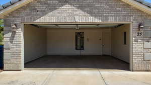Garage with concrete driveway and electric panel