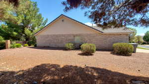 View of side of property featuring brick siding