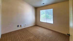 Empty room with baseboards and carpet