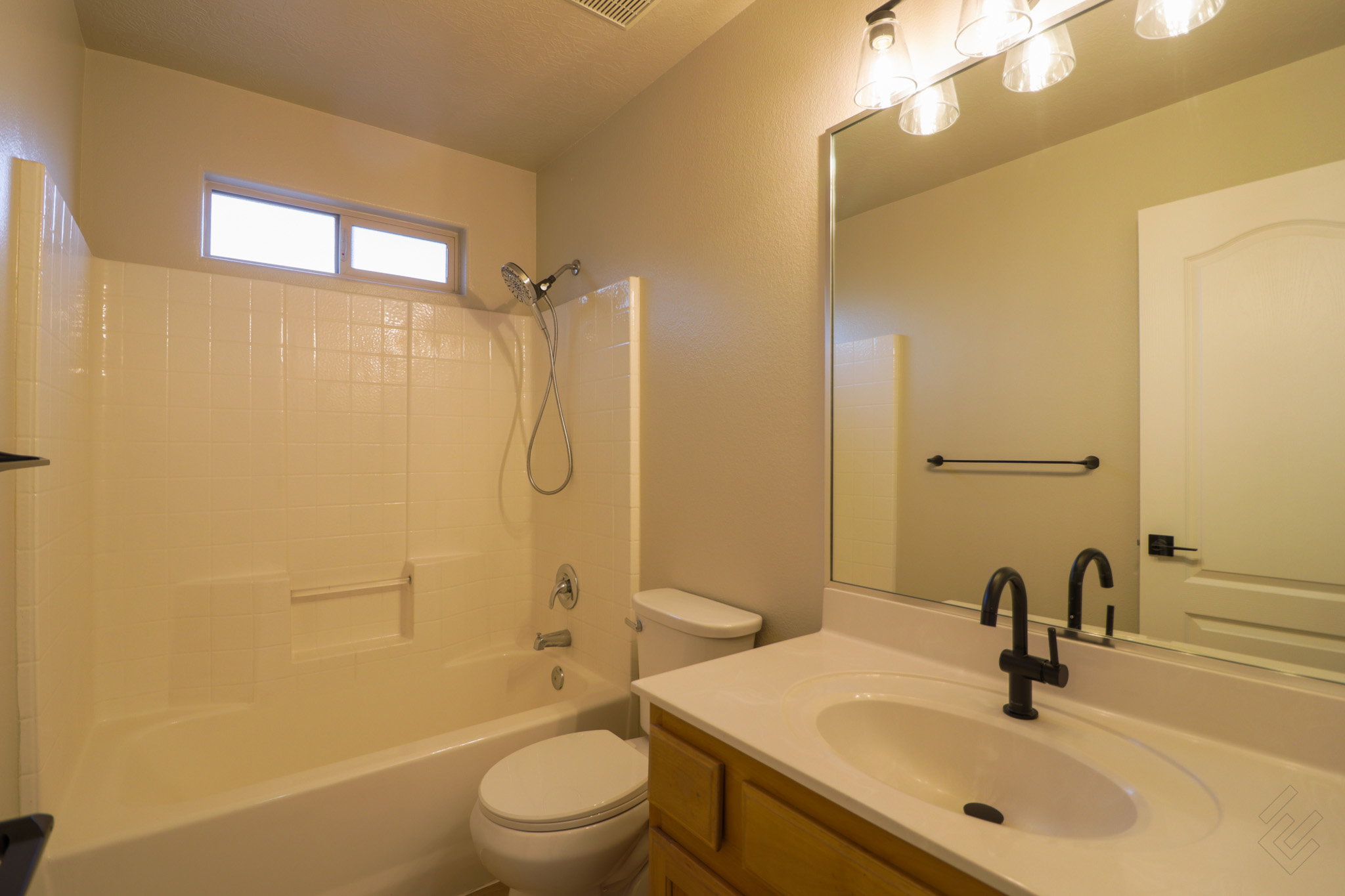 Full bathroom with vanity and washtub / shower combination