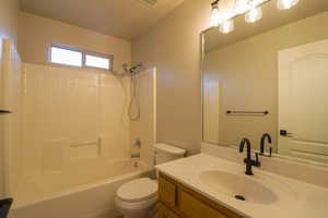 Full bathroom with vanity and washtub / shower combination