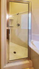 Full bathroom with a stall shower and a garden tub