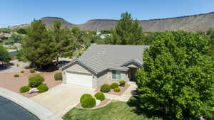 Aerial view of property and surrounding area featuring mountains