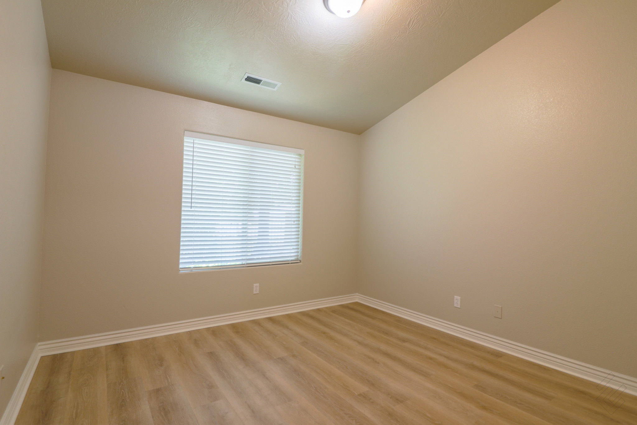 Unfurnished room with vaulted ceiling and light wood-style floors