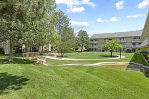 View of property's community featuring a yard