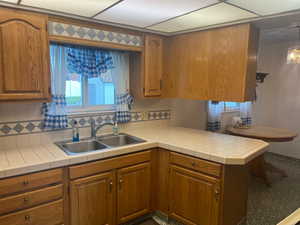 Kitchen featuring brown cabinets and refrigerator