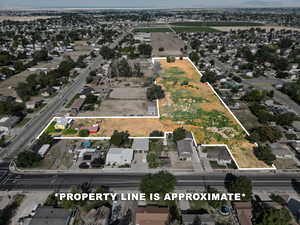 Aerial view of property and surrounding area featuring property parcel outlined
