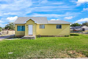 Bungalow with a trampoline and a shingled roof