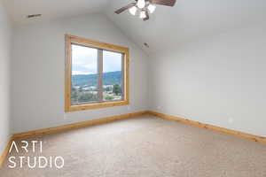 Empty room with carpet floors, lofted ceiling, ceiling fan, and a mountain view