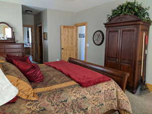 Bedroom featuring connected bathroom and carpet