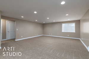 Carpeted empty room with recessed lighting