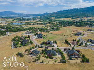 Aerial view of property's location featuring a water and mountain view and nearby suburban area