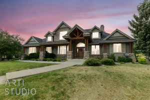 Craftsman inspired home featuring a lawn, a chimney, and stone siding