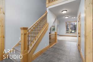 Staircase with baseboards and carpet