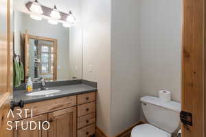 Half bath featuring toilet and vanity