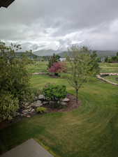 View of grassy yard featuring a mountain view