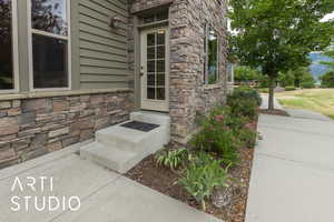 Entrance to property with stone siding