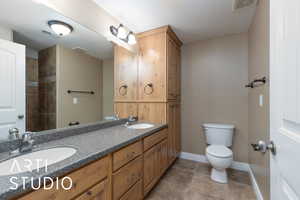 Bathroom with toilet and double vanity