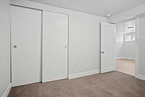 Unfurnished bedroom with carpet floors and a closet
