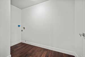Unfurnished room with baseboards and dark wood finished floors