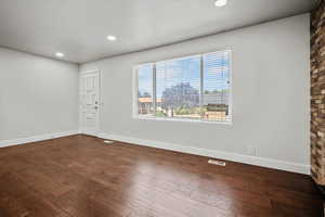 Foyer entrance with dark wood-type flooring and recessed lighting