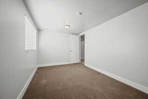 Empty room featuring carpet and a textured ceiling