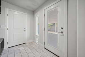 Foyer entrance featuring baseboards