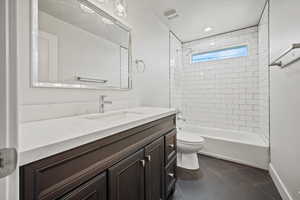 Bathroom featuring vanity, tile patterned flooring, shower / washtub combination, and recessed lighting