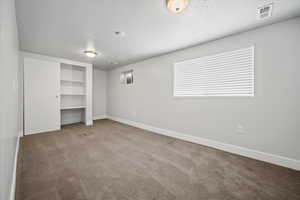 Unfurnished bedroom with carpet flooring and a textured ceiling