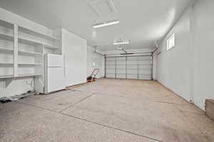 Garage featuring freestanding refrigerator