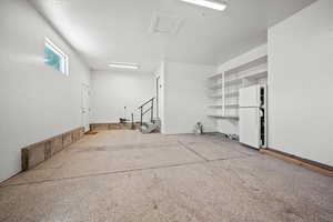 Garage featuring freestanding refrigerator