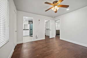 Unfurnished bedroom featuring recessed lighting, hardwood / wood-style floors, a walk in closet, connected bathroom, and ceiling fan