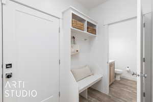 Mudroom featuring light wood-style floors and baseboards