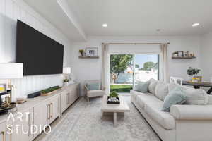 Living room featuring light wood finished floors and recessed lighting